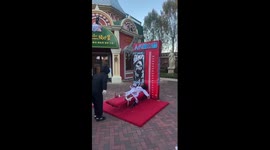 Fairground strongman game switches weight for decapitated head for Halloween