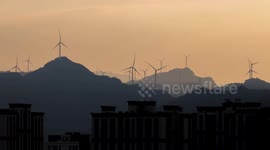 China: Wind turbines on the mountain spin against the wind on the Jinfo mountain in Chongqing
