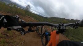 DOWNHILL ENDURO MTB RIDER CRASHES ON A BIG JUMP HEAD FIRST ON TO A ROCK