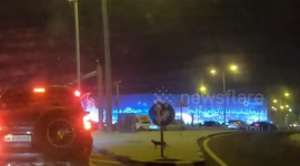 Cat caught on car dashboard camera roaming aimlessly on Qatar roads, trying to cross the road make a hasty retreat after seeing the cars at the singal crossing