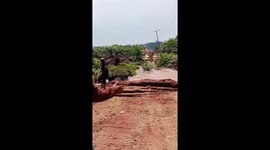 Soil collapses and swallows excavator as driver jumps to safety