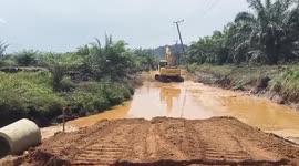 Soil 'turns to liquid' and swallows digger as driver jumps to safety
