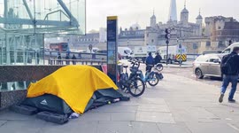 A Person Appears To Be Camping Inside A Yellow Tent Nearby Tower Bridge