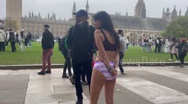 A silent protest with a partly dressed woman amongst handsmaids was held in central London to highlight the in justice to Ahoo Daryaei and women in Iran.  London /UK