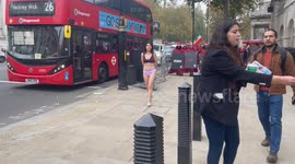 A silent protest with a partly dressed woman amongst handsmaids was held in central London to highlight the in justice to Ahoo Daryaei and women in Iran.  London /UK