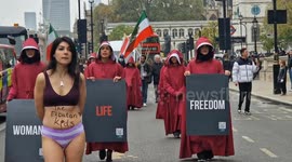 Women in Handmaid's Tale oufits march in London for student Ahoo Daryaei detained by Iranian morality police after ome-woman hijab protest