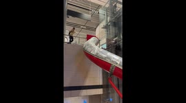 Passenger whizzes down slide at Singapore airport