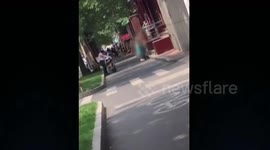 Two men take off clothes to help a woman cover her naked body