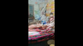 Young Chinese child cares for paralyzed father with daily exercises