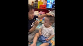 Sister sticks spinning fan toy on brother’s forehead in China