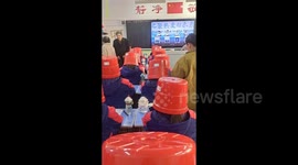 Chinese school hosts unusual parent-teacher event: Students wear buckets over heads as parents guess who's who