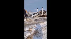car with passengers sinking in ice