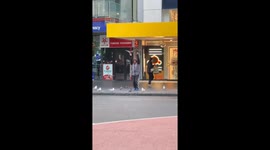 Person in Auckland performs slow movements with pigeons in hands