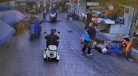 Heroic shopkeeper slides in with foot to prevent falling elderly woman from hitting her head