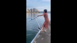 Chinese woman glides on hydrofoil board