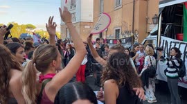 Young women dance with a sign depicting the abortion pill Ru486 during a demonstration for the right to abortion organized by the Not One Less movement in Rome.