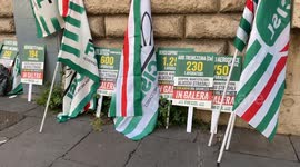 Flags and signs of the CISL union during the sit-in protest promoted by the union against the security decree in Rome.