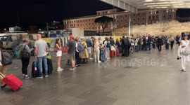 A long line of people waiting to catch a taxi on the day a technical fault blocked Italian trains, outside Rome's Termini Station.