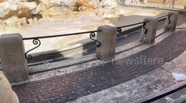 Coins thrown on the ground by tourists and in the background the Trevi Fountain emptied for cleaning work on the occasion of the Jubilee in Rome.