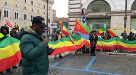 An Ethiopian activist of Amhara ethnicity speaks into a microphone to other participants during the sit-in to denounce the persecution of the Amhara people in Ethiopia, in Rome.