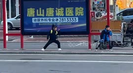 Two kids practice martial arts whilst waiting for bus in China