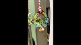 Chinese artisan crafts Christmas wreath with glassblowing