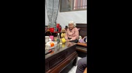 Grandma and dog dozing together captured in Guangdong, China