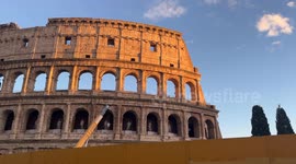 The Colosseum illuminated by sunlight at sunset on an October day in Rome.