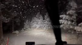 US: Car driving through heavy snowfall in Evergreen