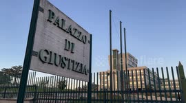 The large writing Palace of Justice on the marble plaque stands out near the entrance to the Courthouse and in the background the Courthouse of Frosinone.