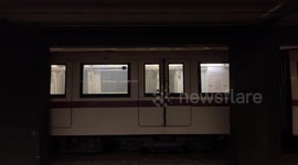 The arrival of a subway train while on the opposite track another empty carriage is stationary at subway stop in Rome.