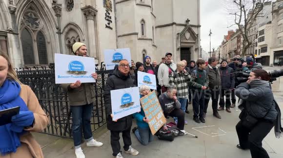 Protesters, including bill payers, MPs, and anti-sewage campaign groups like Surfers Against Sewage and Windrush Against Sewage Pollution, gather outside the High Court in London. The demonstration opposes Thames Water’s proposed £250 annual charge to fun