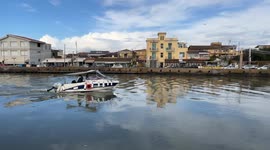 A motorboat sails up the canal port in Fiumicino.