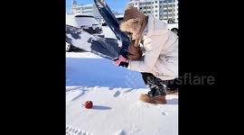 Chinese resident uses frozen jeans to slice apple in half as temperatures fall to -20C