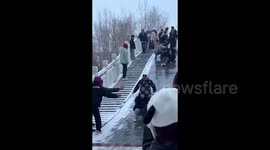 Security guard joins uni students in sliding down icy slope on campus in China