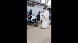 Priest blesses motorcycles and toy car in Sto. Tomas, Philippines