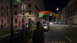 A man waves the Flag of the Movement for a Democratic Society (TEV-DEM) in Rojava during the demonstration called by the Kurdistan Italia Information Office with the slogan 'Defend Rojava' in Rome.