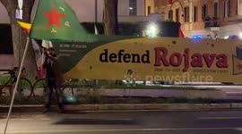 A man waves the Flag of the Movement for a Democratic Society (TEV-DEM) in Rojava during the demonstration called by the Kurdistan Italia Information Office with the slogan 'Defend Rojava' in Rome.