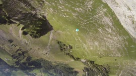Wingsuit flying through a crack with aerial camera