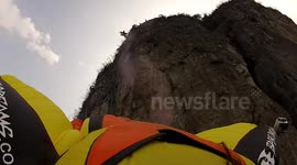 proximity wingsuit flying past a cable car in china back camera