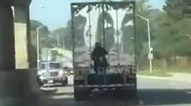 Man on back of truck in Victoria Park, Toronto