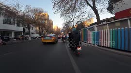 Man kicks down motorcycle parked in the middle of the road in Beijing, China