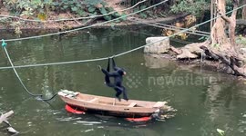 Clever spider monkey uses boat to retrieve floating food at Chinese safari park