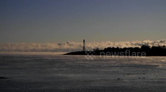 Sea smoke rolls towards harbour in Massachusetts