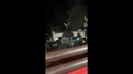 Man attempts to ride mechanical bull in Querétaro, Mexico