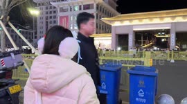 Tourist uses tube of sweets to touch smartphone screen to avoid cold fingers