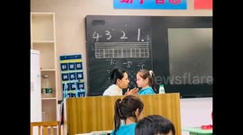 China:  A Teacher Comforts A Crying Student