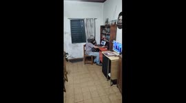 Man watches laptop with birds in Gualeguaychú, Argentina