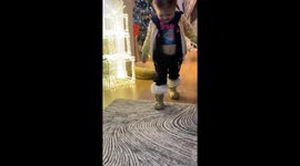Child walks in Christmas tree boots in Liverpool