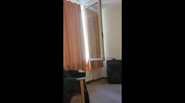 Handheld shot of an open window. Various German Emergency Vehicle Sirens can be heard outside.